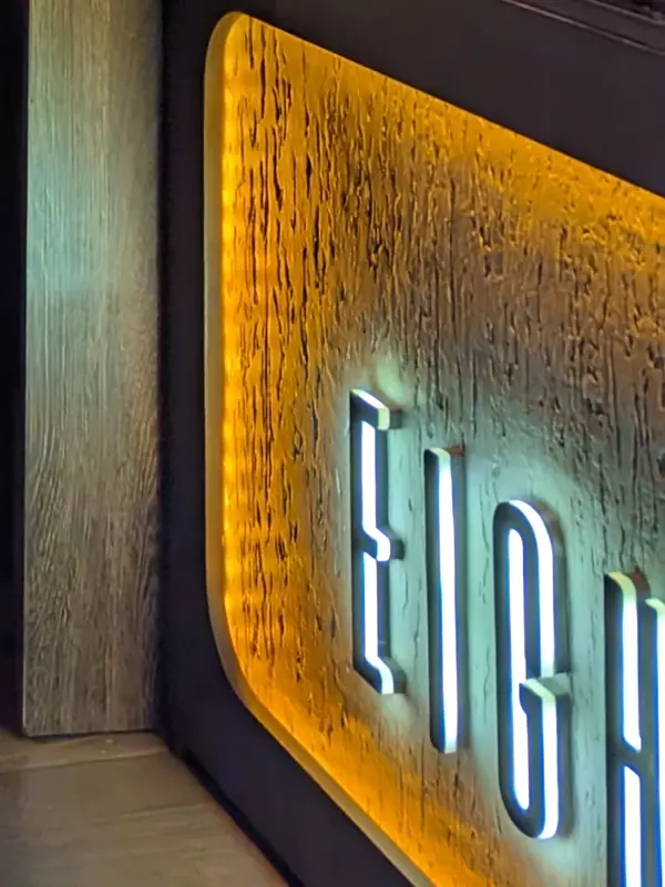 The EIGHT18N letters on the amber-lit bar panel