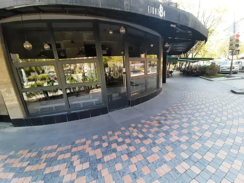The curved glass front under the black awning with the Eight18n logo